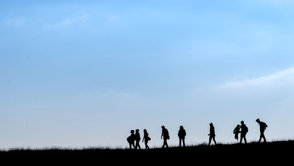 Obraz na płótnie Canvas Silhouette of human scale hike and trail on mountain