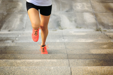 Fototapeta na wymiar Young fitness sport woman running upstairs