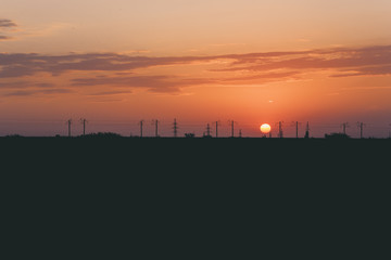 a railroad way silhouette on the orange dramatic sunset background