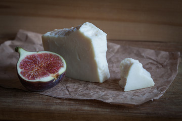 goat cheese with figs on a wooden background