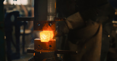 Locksmith working hot iron.