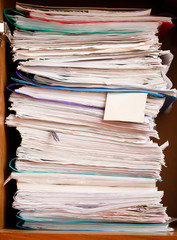 Archive of record. A stack of paper with a blank bookmark on. Keeping files, business documents,...