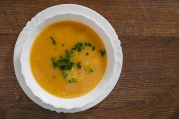Vegetarian cream pea soup on a wooden background. with copy space. top view