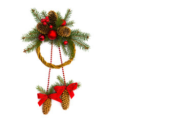 Christmas decoration. Christmas wreath of cones spruce, sprig spruce tree, red balls and hanging of decorative cones spruce with red bow on white background with space for text. Top view, flat lay