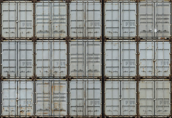 Seamless background of stacked shipping containers.