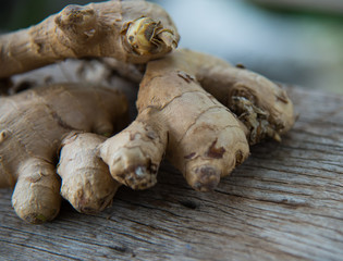Fresh ginger on wood texture.