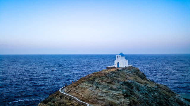 greek orthodox chapel on a cliff on a greek island in the middle of the sea