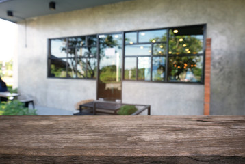 Image of dark wooden table in front of abstract blurred background of outdoor garden lights. can be used for display or montage your products.Mock up for display of product