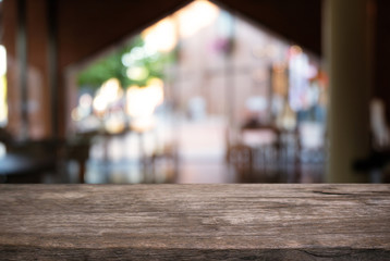 Empty dark wooden table in front of abstract blurred background of coffee shop . can be used for display or montage your products.Mock up for display of product