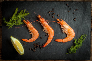 Shrimps for dinner on stone plate.