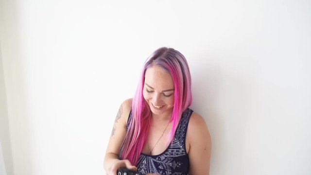 girl with pink hair makes photos on the vintage camera
