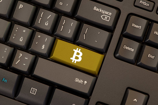 Bitcoin logo concept golden button on keyboard