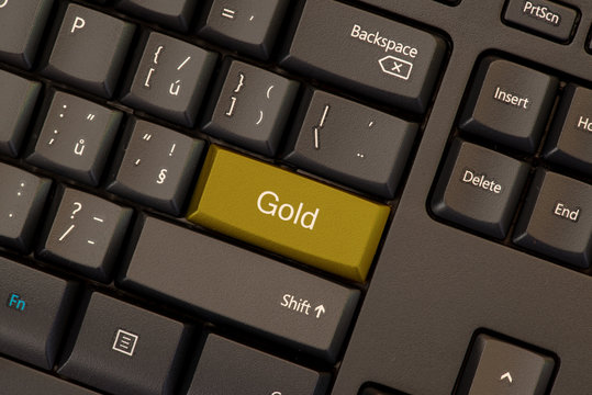 Gold word concept on golden button on keyboard
