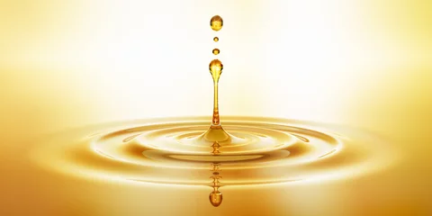 Fotobehang Tropfen aus goldenem Öl © peterschreiber.media