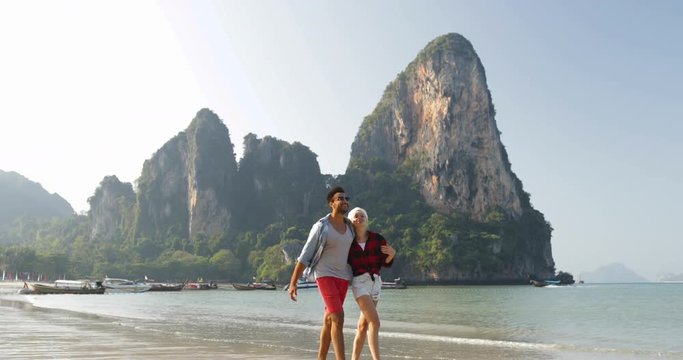 Couple Walking On Beach Embracing Young Man And Woman Tourists On Sea Vacation In Thailand Slow Motion 60
