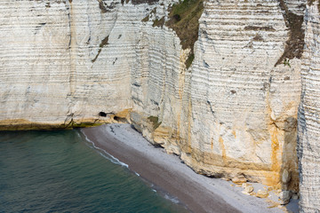 Colorful vertical limestone cliffs with beach near Etretat in Normandy, France