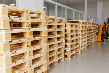 few empty wooden pallets for storage in an empty warehouse. 