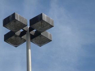 battered lamppost over blue sky