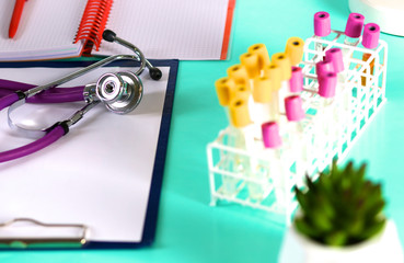 Doctor's workspace working table with patient's discharge blank paper form, medical prescription, stethoscope on desk