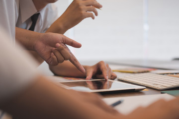 Obraz premium interior designer working with graphic tablet at workplace. artist discussing design and idea at office. business people brainstorming for new creativity project. teamwork, partnership