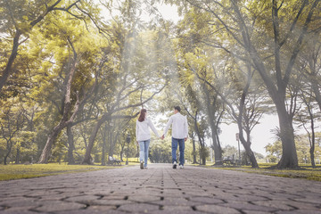 couple is walking in a park, in a blurred vintage mood