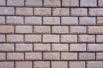 Brick wall made of red stone background. The spoiled brick is vintage.