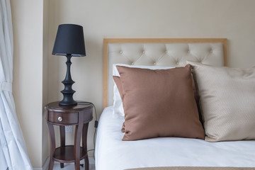 set of brown pillows on bed in classic bedroom
