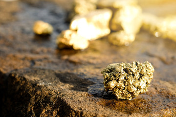 The pure gold ore found in the mine on a stone floor
