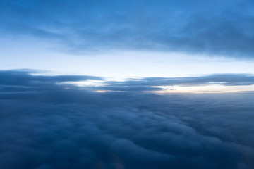 Sunrise above clouds seen through airplane window