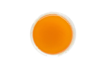 Honey in a round plastic container top view Isolated on white background