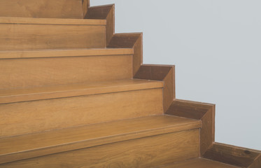 Fototapeta na wymiar Wooden staircase and white wall
