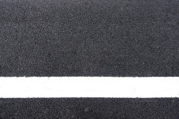 Fototapeta premium white lines on the asphalt road surface background texture