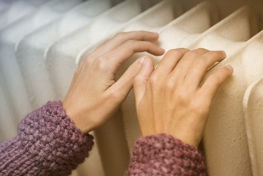 Hands Warming With Heating Radiator
