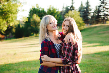 Fototapeta premium Two girls friends laughing and hugging. Hug and smile outdoor