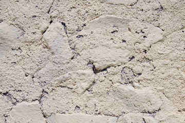 detail of beige rough wall, closeup, Santorini Greece.