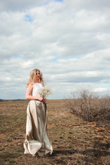 Fototapeta na wymiar Portrait of beautiful blond woman in a field