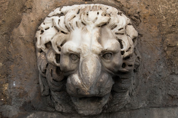  antique lion head made of bright marble gouged out by time