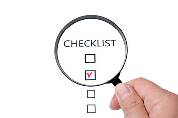 Checklist on white paper with Magnifier