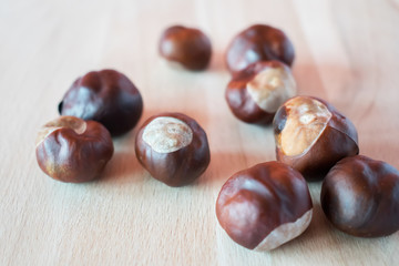Fresh chestnuts on wooden background