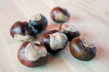 Fresh chestnuts on wooden background