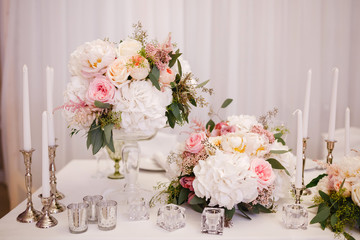 Table decor with white flowers and candles for a wedding party