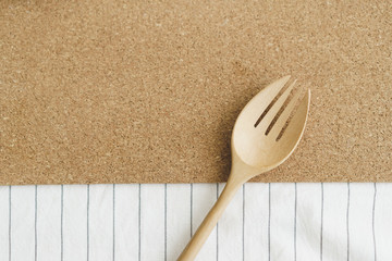 Top view of wooden fork on table cloth.
