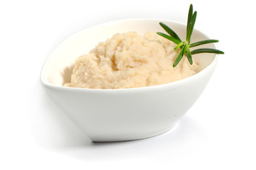 Horseradish sauce in small glass bowl isolated on white background