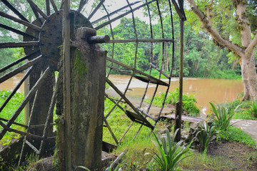 The old steel water turbine,Thai style in a forest