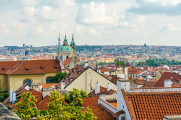 Fototapeta na wymiar Prague. Czech Republic. View from the Prague Castle. Cathedral of St. Mikulas. Red tiled roofs