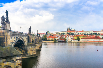 Fototapeta na wymiar Prague Castle. The Charles Bridge. Medieval fortress. The Vltava River. Cathedral of St. Mikulas. Red tiled roofs