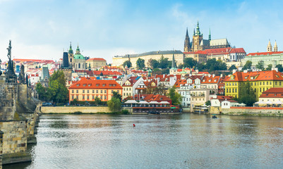 Obraz premium Prague Castle. The Charles Bridge. Medieval fortress. The Vltava River. Cathedral of St. Mikulas. Red tiled roofs