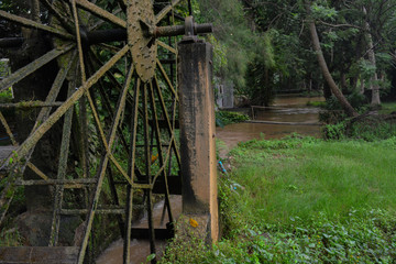 The old steel water turbine,Thai style in a forest