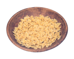 Farfalle durum semolina pasta in wooden bowl isolated on white background