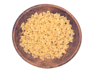 Farfalle durum semolina pasta in wooden bowl isolated on white background
